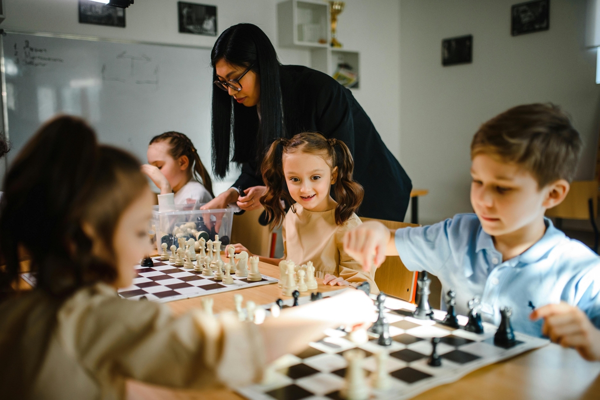 Students playing chess at summer camp.